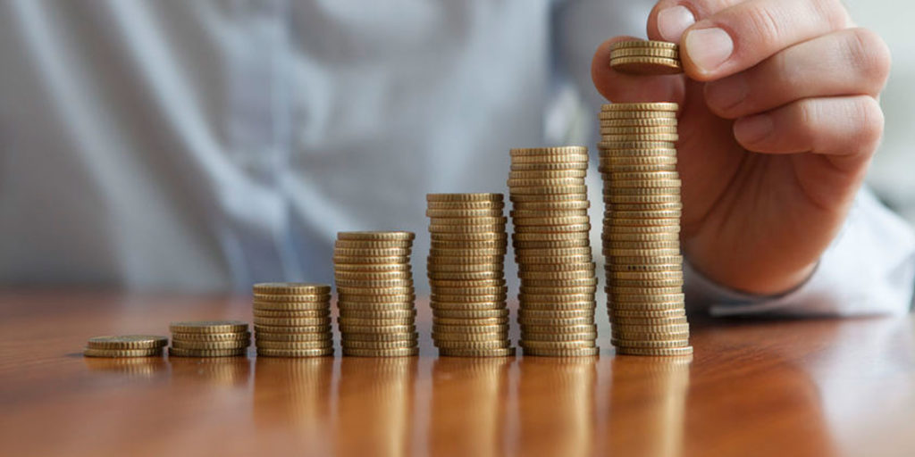 stacks of coins representing the revenue earned from the help of a digital marketing agency