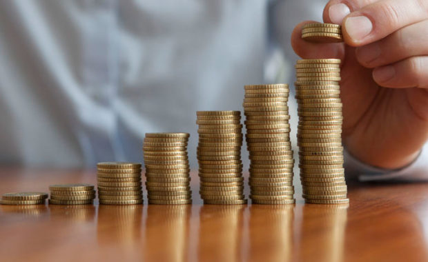 stacks of coins representing the revenue earned from the help of a digital marketing agency