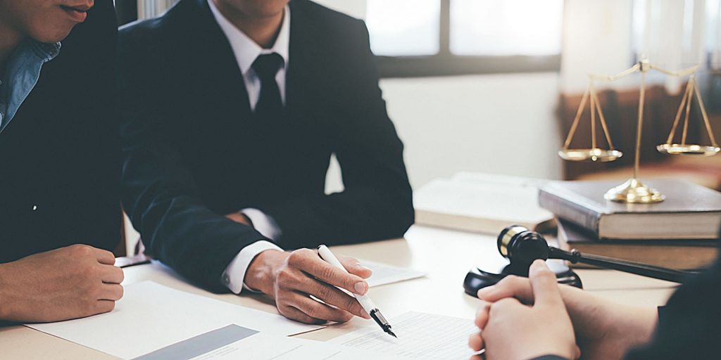 an attorney signing a document with a law firm marketing agency to discuss how digital marketing will be beneficial to his firm and book of clients