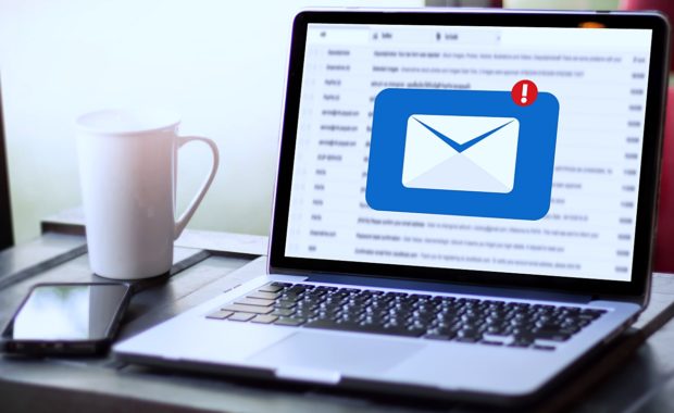 a coffee mug next to a phone and a laptop that shows an email that was received from a customer as a part of an email marketing campaign for a local business