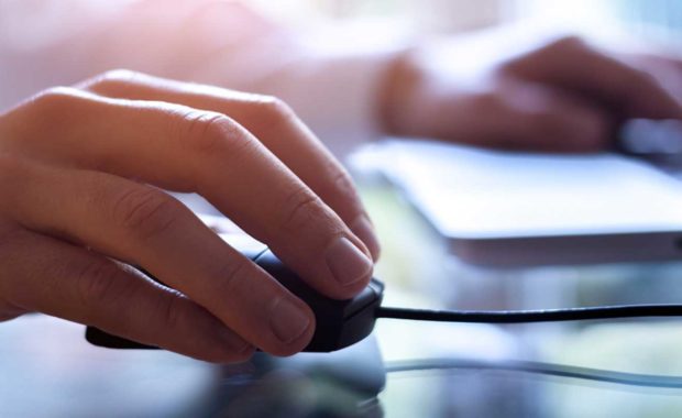 Person at computer performing organic SEO