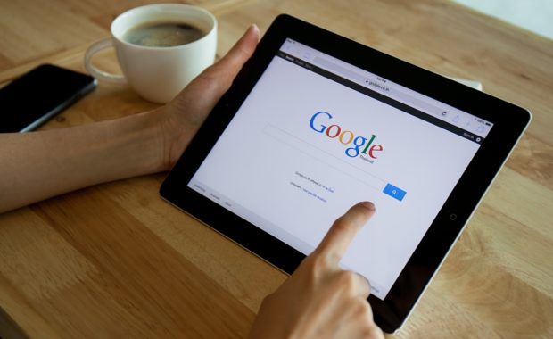 an individual using google to research seo vs sem