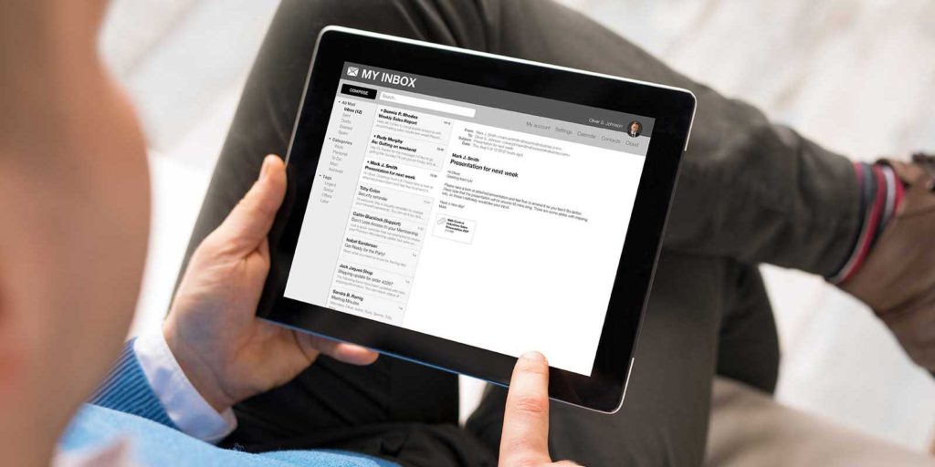 man reviewing his email marketing campaign on a tablet