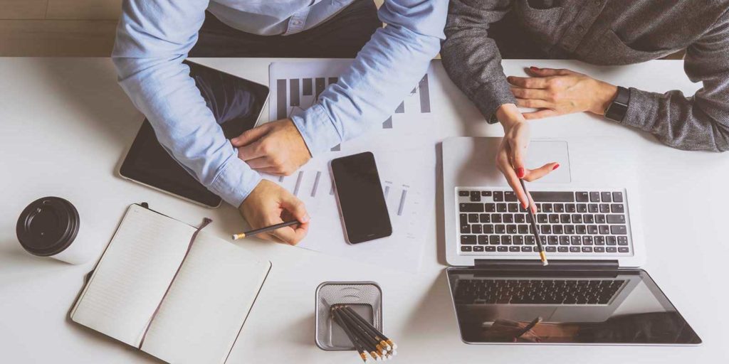 marketer showing insurance agent the progress of his insurance marketing campaign