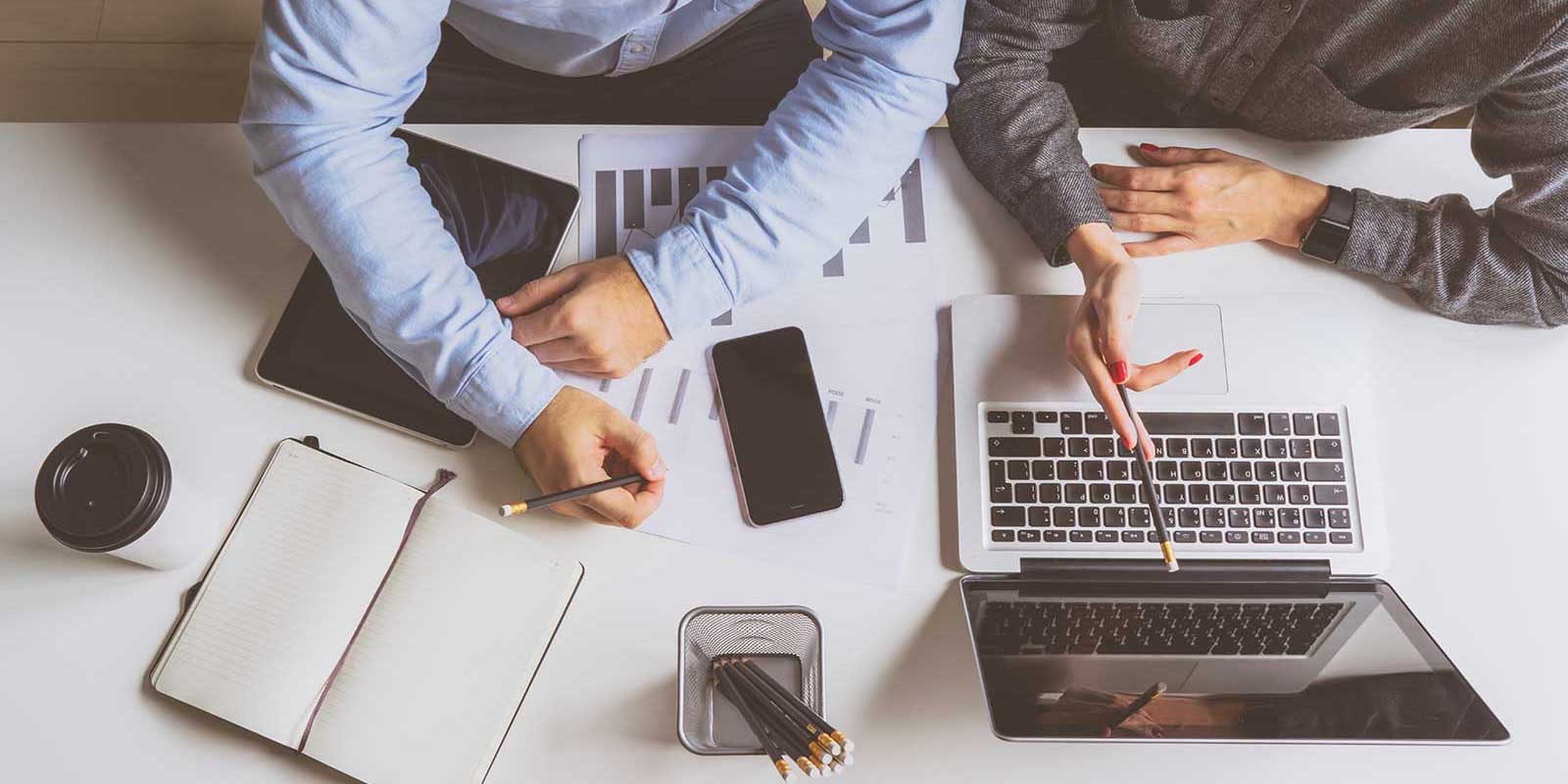 marketer showing insurance agent the progress of his insurance marketing campaign