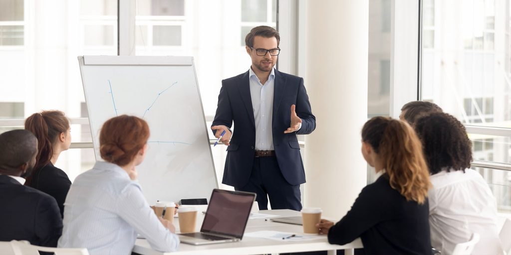 Male business coach speaker in suit give flipchart presentation