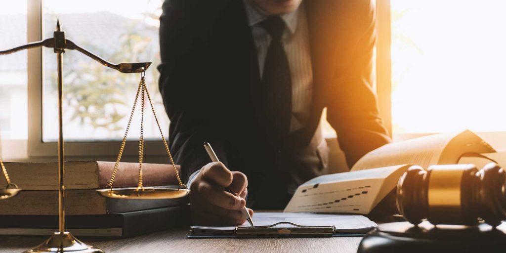 Attorney writing down law firm marketing ideas