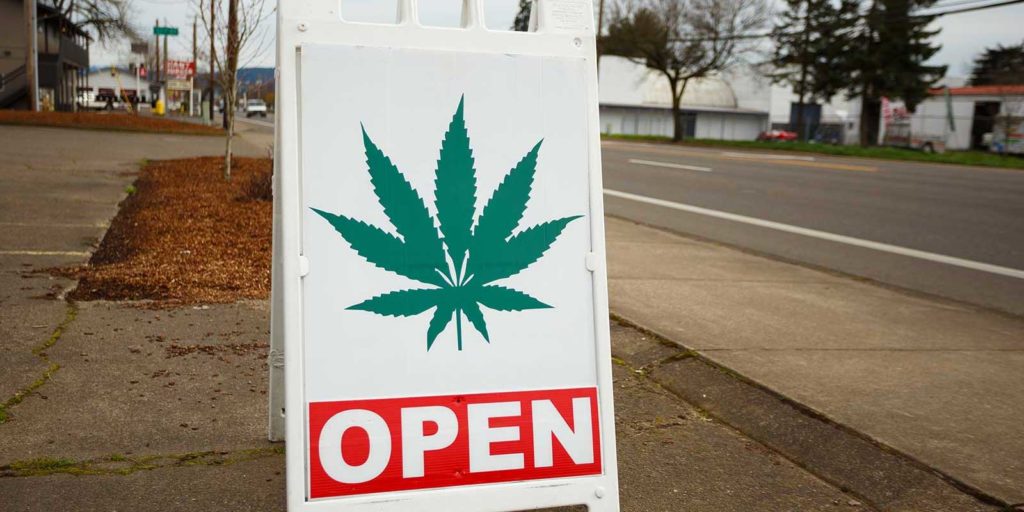 Open sign for dispensary who read how to market your dispensary in 2021