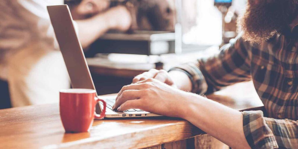 man working on updating his old blog for content marketing