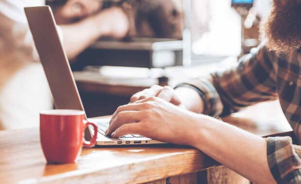 man working on updating his old blog for content marketing