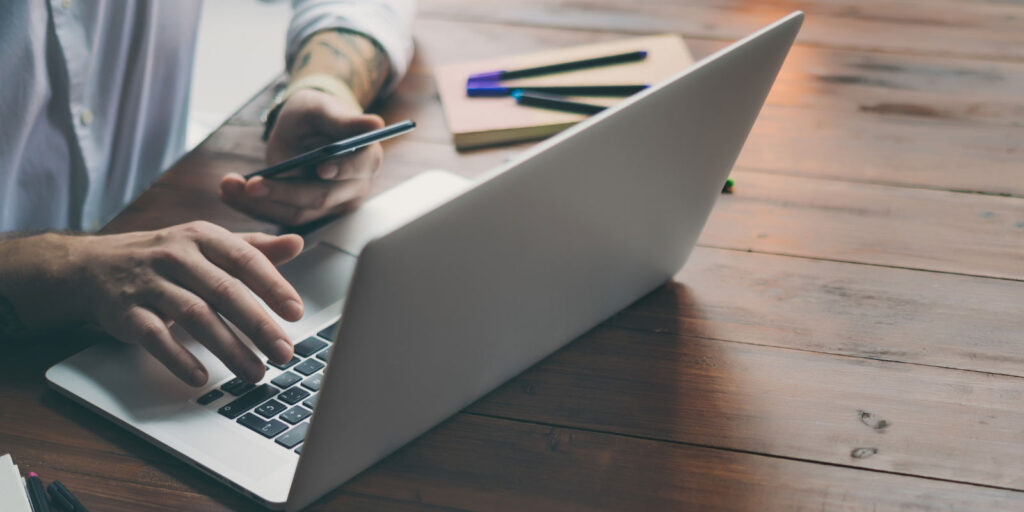 Person typing on their laptop