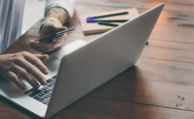 Person typing on their laptop
