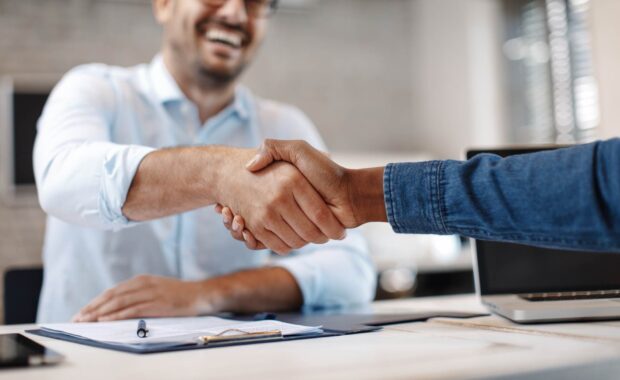Insurance agent shaking digital marketer hand