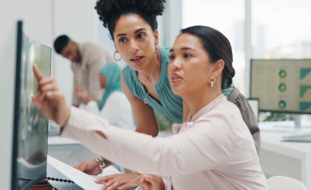 Digital marketing strategists reviewing stats