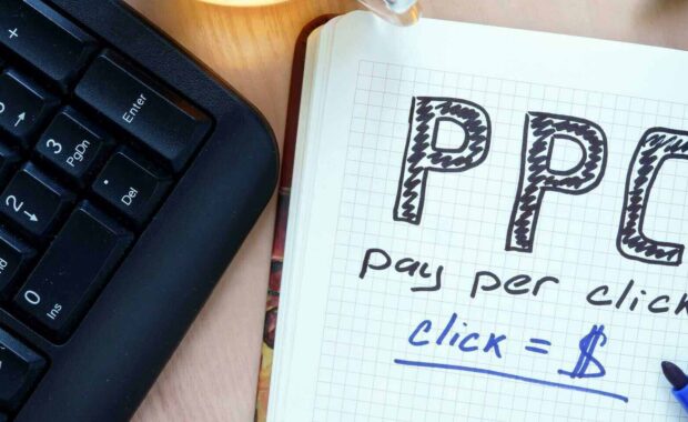 notepad with words ppc pay per click concept and marker