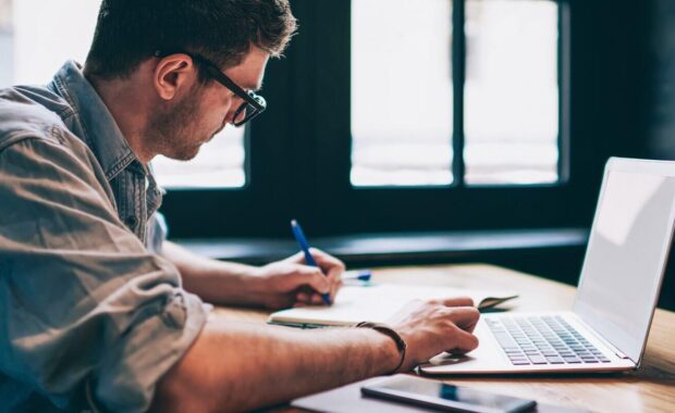 captive insurance agent searching information for on laptop