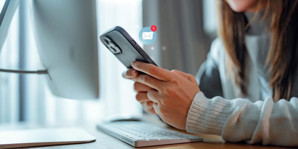 woman hands using smartphone receiving text message marketing from insurance company