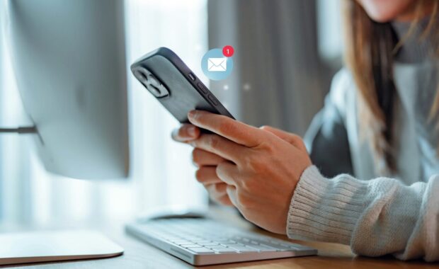 woman hands using smartphone receiving text message marketing from insurance company
