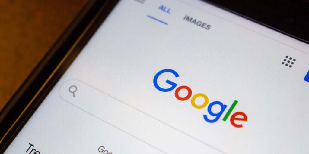 google website on an iPhone on wooden table