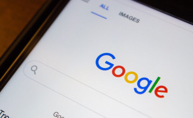 google website on an iPhone on wooden table