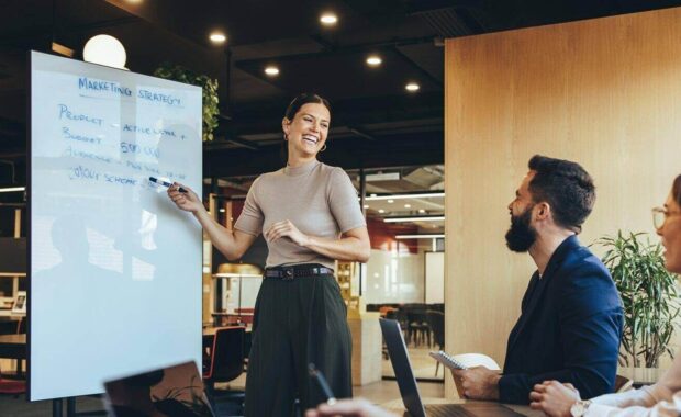 cheerful business manager giving a presentation about fractional marketing