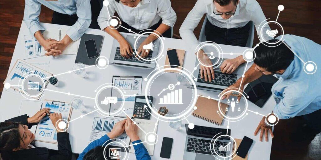 view analyst team utilizing BI Fintech to analyze financial data at table in meeting room