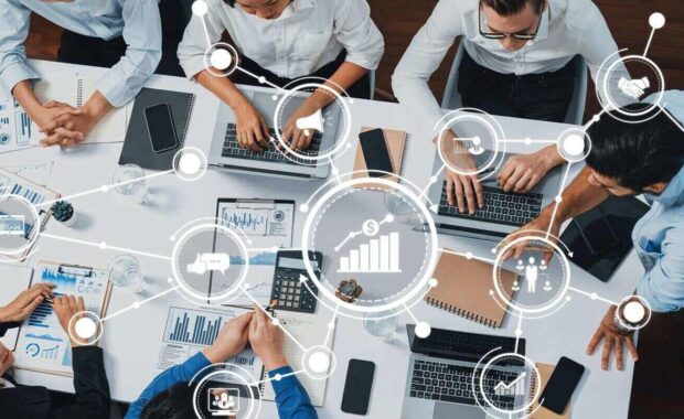 view analyst team utilizing BI Fintech to analyze financial data at table in meeting room
