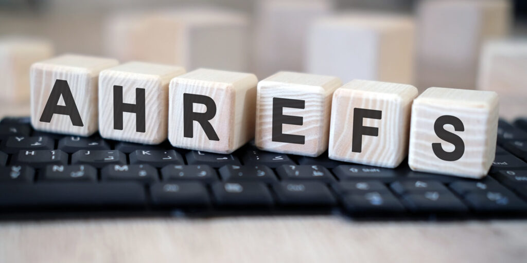 ahrefs - text cubes stand on a black keyboard on a wooden table
