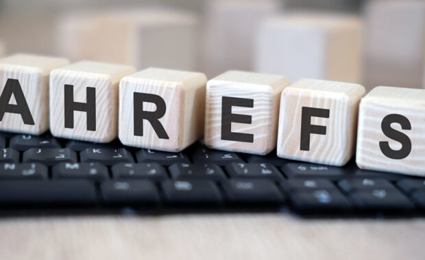 ahrefs - text cubes stand on a black keyboard on a wooden table