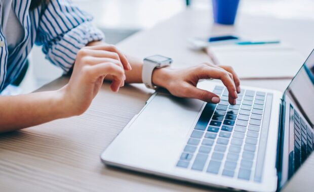 image of female hands searching web information during social networking via modern laptop computer